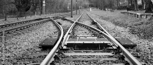 Wide angle railway track joining in monochrome