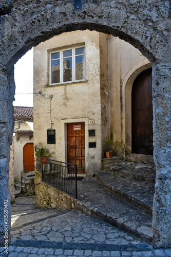 Fototapeta Naklejka Na Ścianę i Meble -  Prata Sannita, Italy, 01/13/2020. A narrow street between the old houses of a medieval village