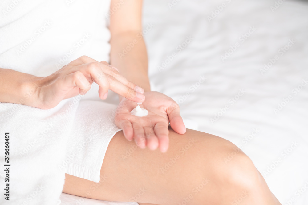 Fototapeta premium Woman applying moisturizing cream/lotion on hands, beauty concept..