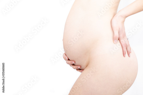 Young pregnant naked woman