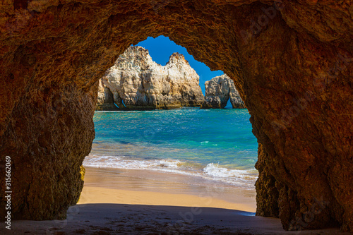 Natural caves in the impressive cliffs of Algarve coast in Portugal in summer