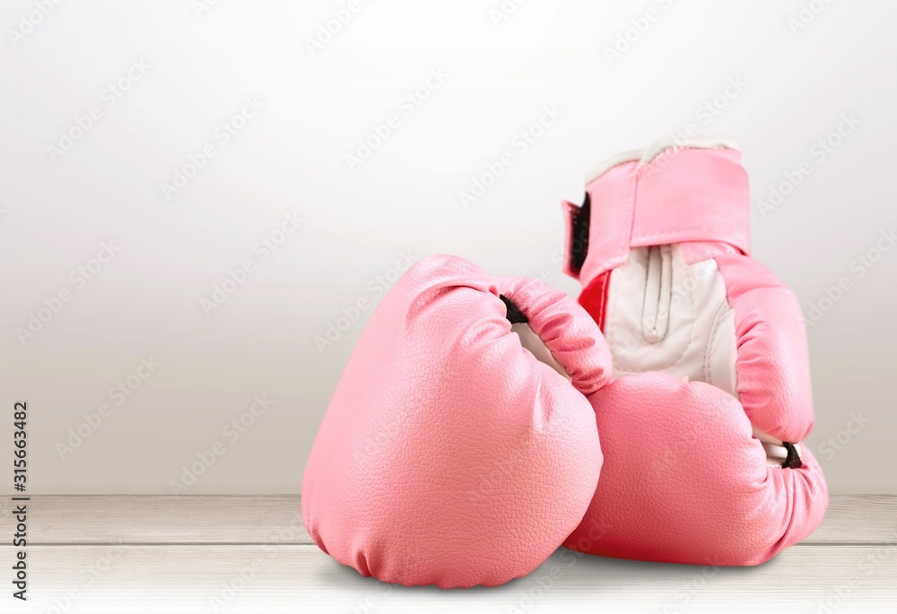 Sports pink boxing gloves on pastel background