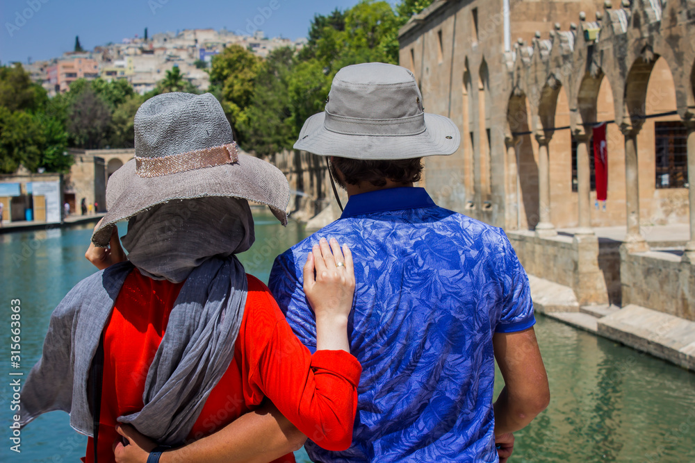 Sanliurfa, Chemical hat in front of two tourists holding each other dear, Sanliurfa, Chemical hat in front of two tourists holding each other dear,