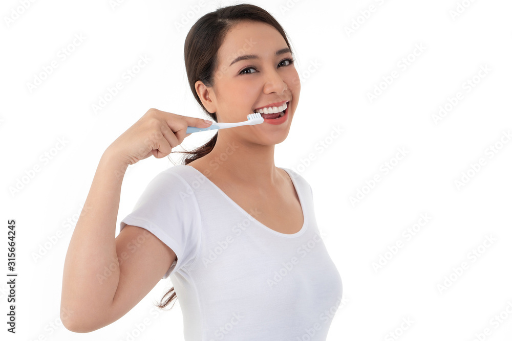 Beautiful Asian woman holding a toothbrush for brush teeth. Her is smile and teeth are white and beautiful and look hygiene. Concept for oral and dental care on the dentist advice Beautiful Asian woman holding a toothbrush for brush teeth. Her is smile and teeth are white and beautiful and look hygiene. Concept for oral and dental care on the dentist advice