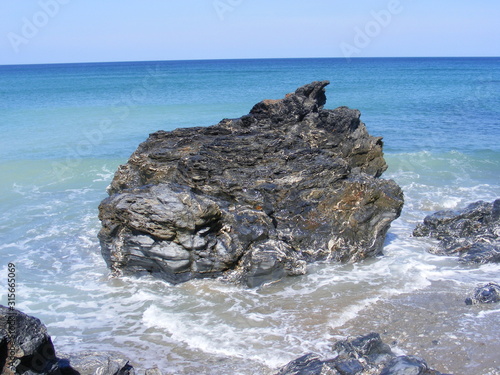 Tide coming in around rocks on the beach