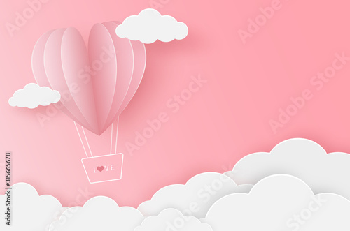 Paper heart balloon flying on the pink sky