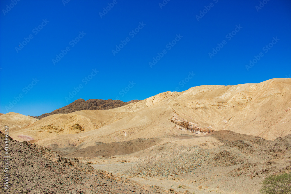 sand stone desert rocky hills landscape wilderness scenic view environment vivid blue sky background space