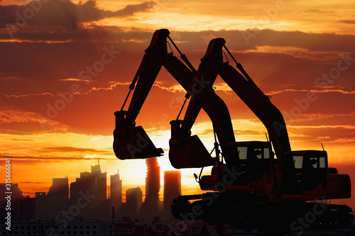 Wallpaper Mural Two Black silhouette of backhoe loader with sunset light background,In cityscape Torontodigital.ca