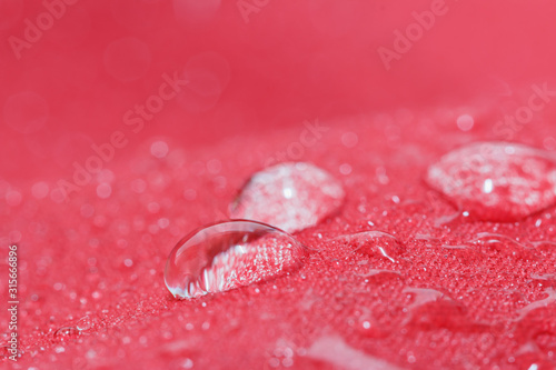  Water droplets on a red waterproof fabric background