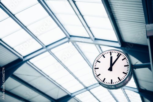 Public indoor clock and skyroof in train station, clock show time waiting train for passengers or commuters