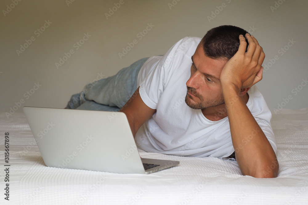 Man With Laptop In Bed. Man With Laptop In Bed.