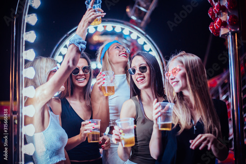 Group of friends toasting and having fun in the club