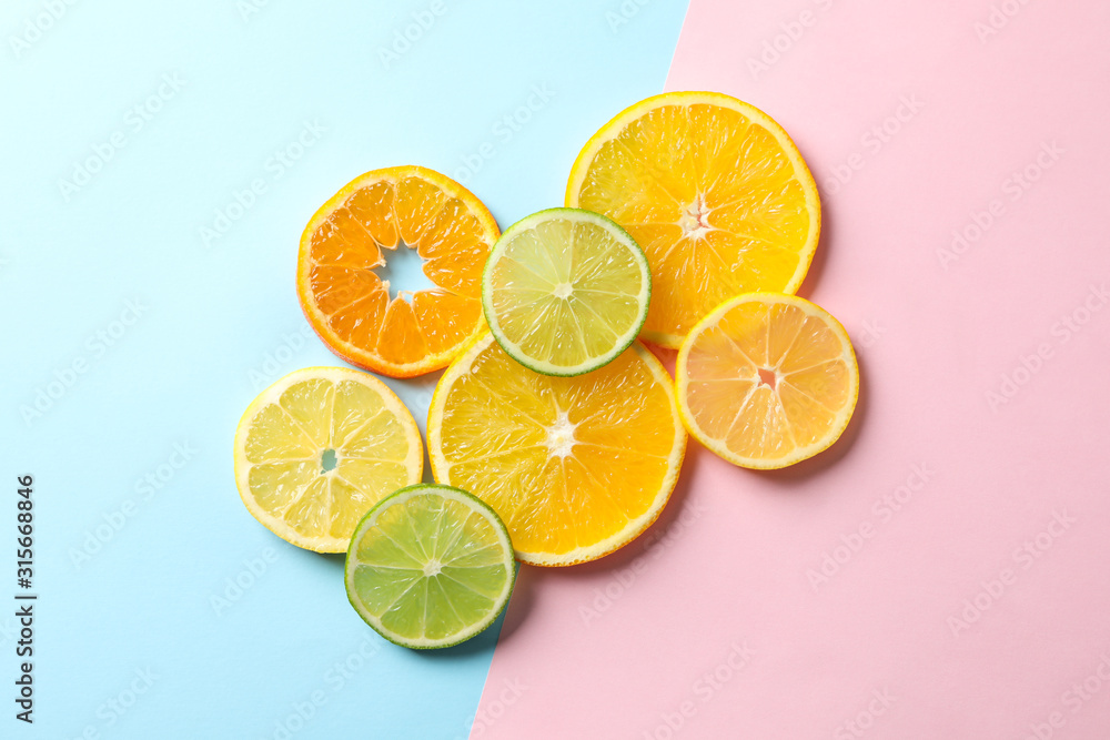Citrus fruits slices on two tone background, top view Citrus fruits slices on two tone background, top view