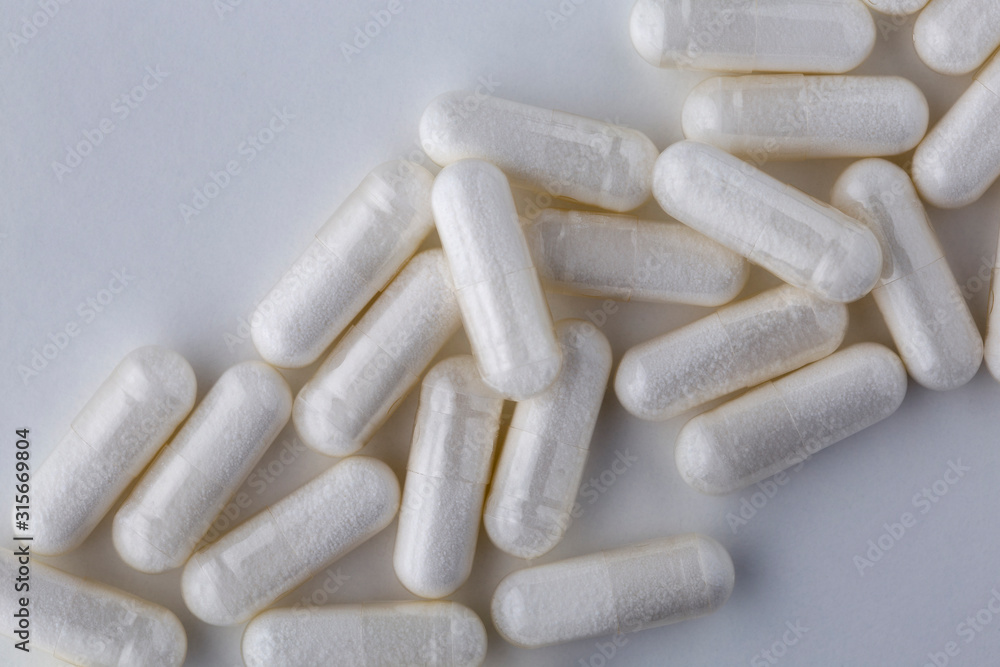 Pills tablets vitamins capsules drugs white close up macro shot Pills tablets vitamins capsules drugs white close up macro shot