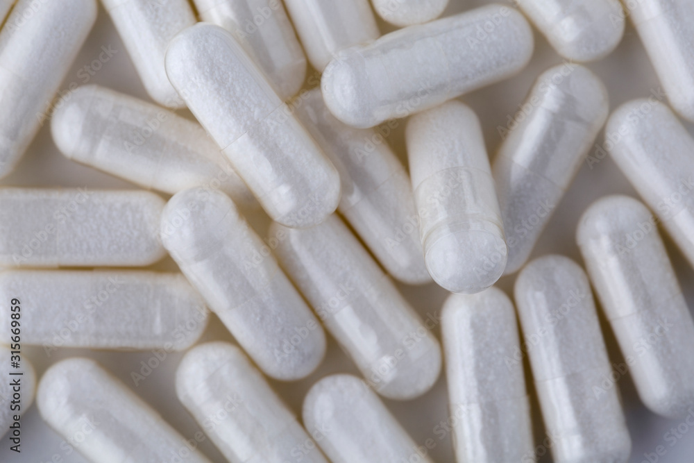 Pills tablets vitamins capsules drugs white close up macro shot Pills tablets vitamins capsules drugs white close up macro shot