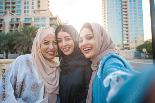 Canvas Print Three women friends going out in Dubai