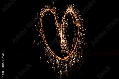 Heart made of Sparklers with Black Background