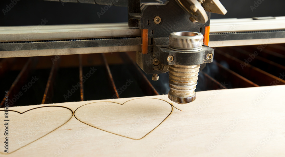 Laser cutting machine is cutting the wooden plank - obrazy, fototapety, plakaty 