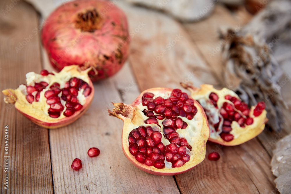 ripe organic pomegranate on teh wooden background ripe organic pomegranate on teh wooden background
