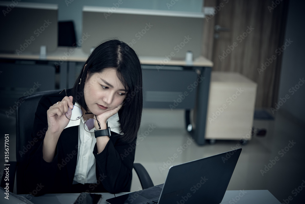 Asian woman working in office,young business woman stressed from work overload with a lot file on the desk,Thailand people thinking something Asian woman working in office,young business woman stressed from work overload with a lot file on the desk,Thailand people thinking something