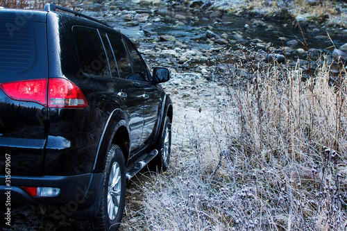 Off-road car driving mountain river