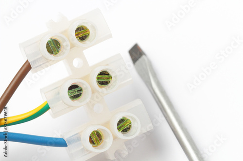 Photos Screw terminal electrical connector to connect wires,  close-up, white background