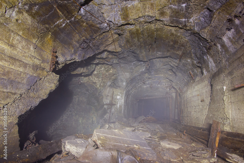Underground gold mine shaft tunnel with fog