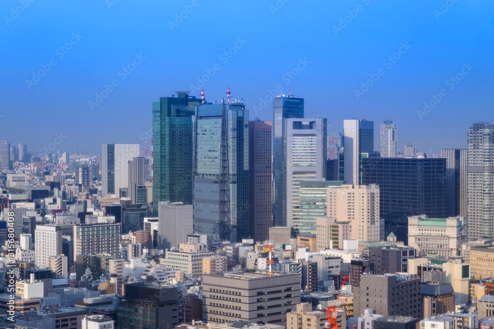 Landscape of tokyo city skyline in Aerial view with skyscraper, modern office building and blue sky background in Tokyo metropolis, Japan.