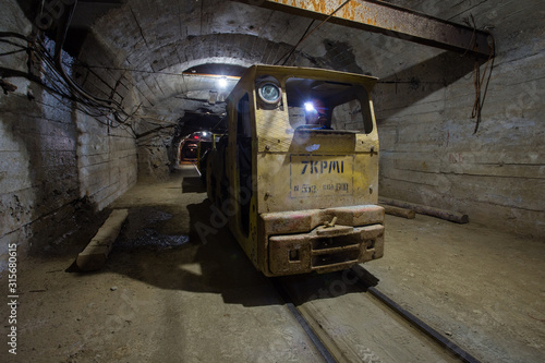Underground gold mine shaft tunnel drift with electric locomotive