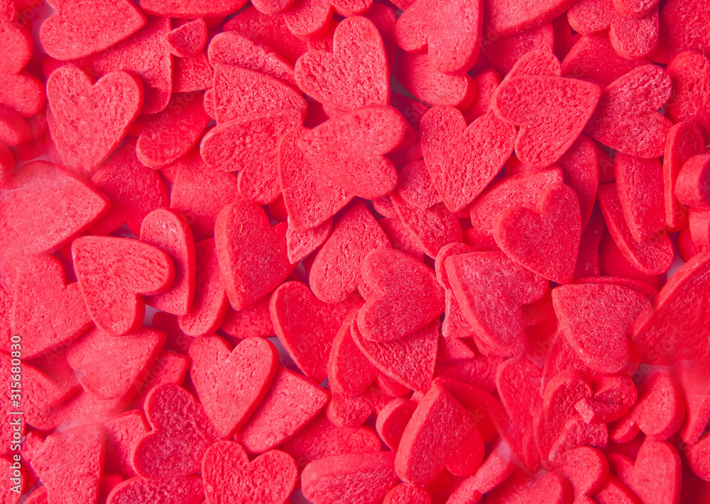 Valentines day background with red heart shaped candies Valentines day background with red heart shaped candies