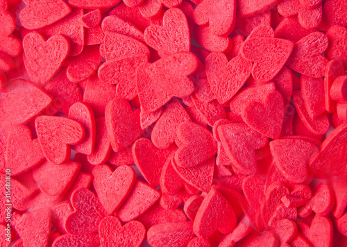 Valentines day background with red heart shaped candies
