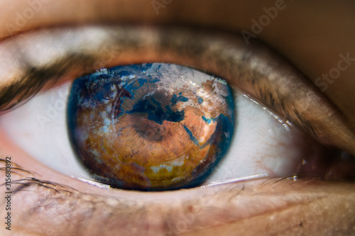 Close-up of planet earth in the ye of a child. View of a child on the environmental world.