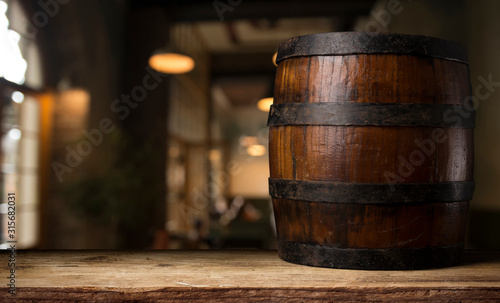 Beer barrel with beer glasses on a wooden table. The dark brown background.