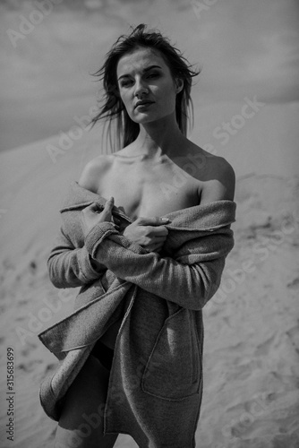 Woman with fit body portrait in desert 
