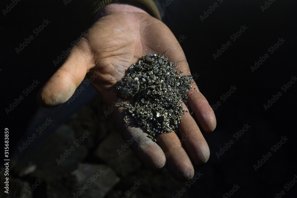Gold ore pyrite specimen in miners hand
