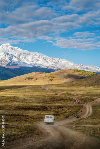 Altai Republic, Russia - September, 16, 2019: UAZ off-road minibus rides along a field road in the Kurai steppe