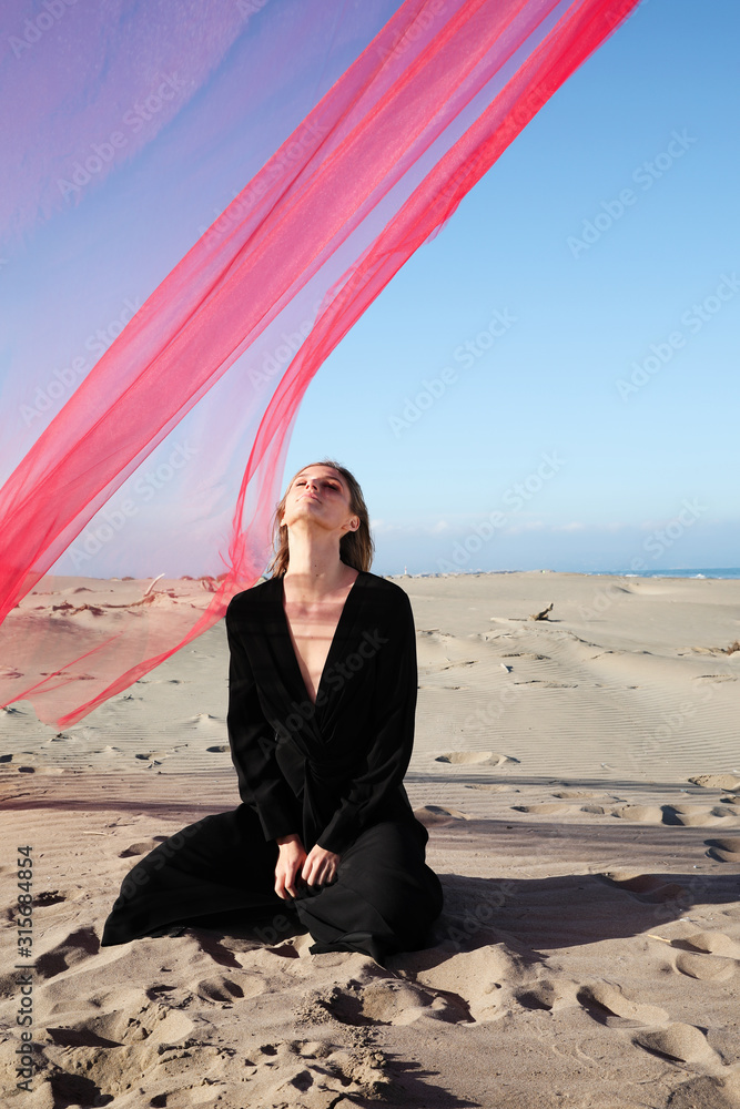 Young woman enjoying sunny weather on the beach.