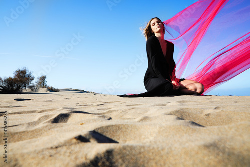 Young woman enjoying sunny weather on the beach.