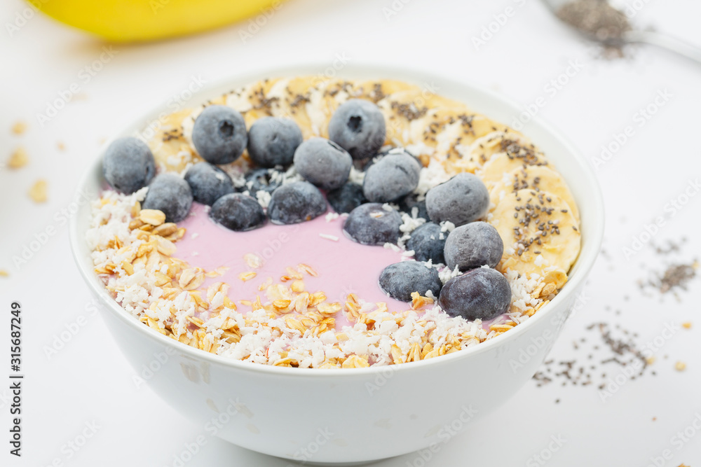 Healthy smoothie bowl with yogurt, blueberry, bananas, coconut, chia seeds and granola Healthy smoothie bowl with yogurt, blueberry, bananas, coconut, chia seeds and granola