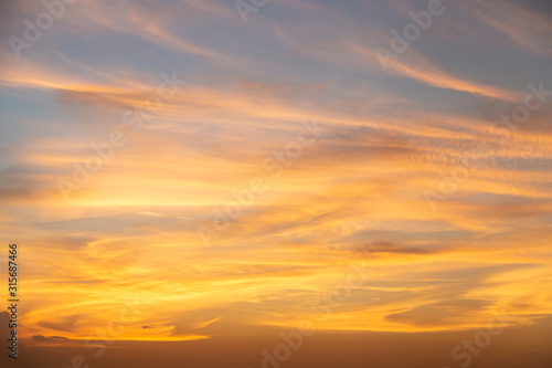 Beautiful sunset on the sky over the building in the capital of Thailand. Orange sky with clouds in the evening. Can use for add text and abstract background. © witsawat