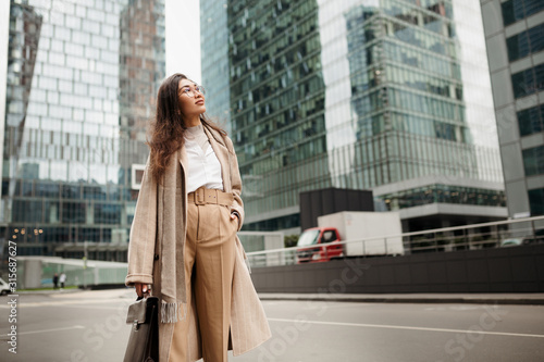 Photography Beautiful Asian girl Manager looks admiringly at the business skyscrapers of Mos