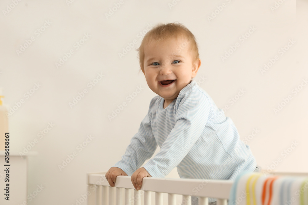 Cute little baby in crib at home Cute little baby in crib at home