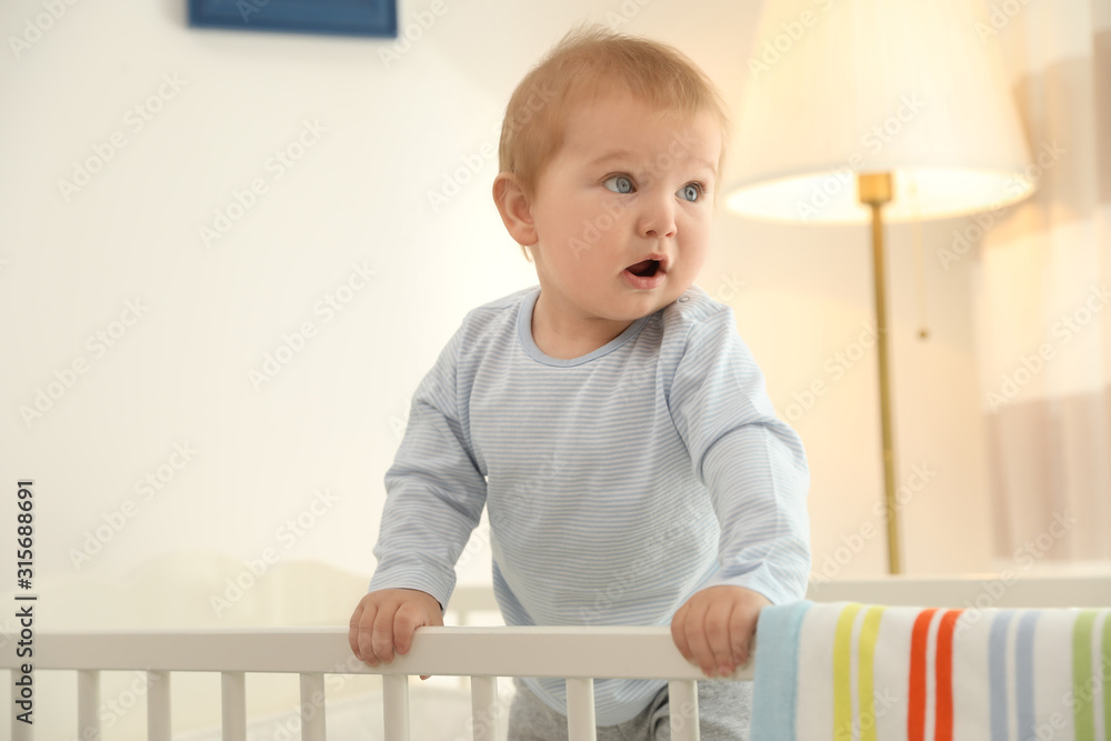 Cute little baby in crib at home Cute little baby in crib at home