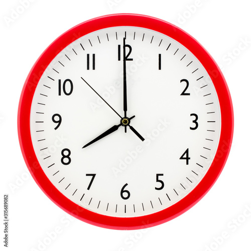 Clock with red round frame on white isolated background shows 8(20) hours 00 minutes_