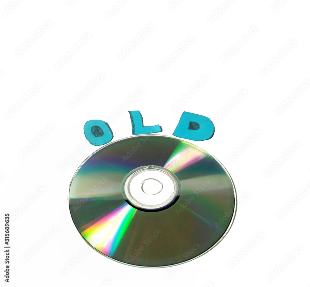 Compact disk on white background and the word old. obsolete technology concept Compact disk on white background and the word old. obsolete technology concept
