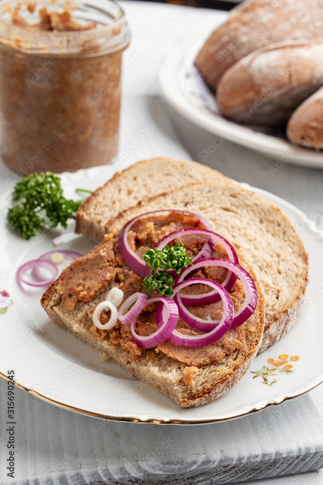 Slices of bread slathered with pork lard mixed with ground cracklings Slices of bread slathered with pork lard mixed with ground cracklings