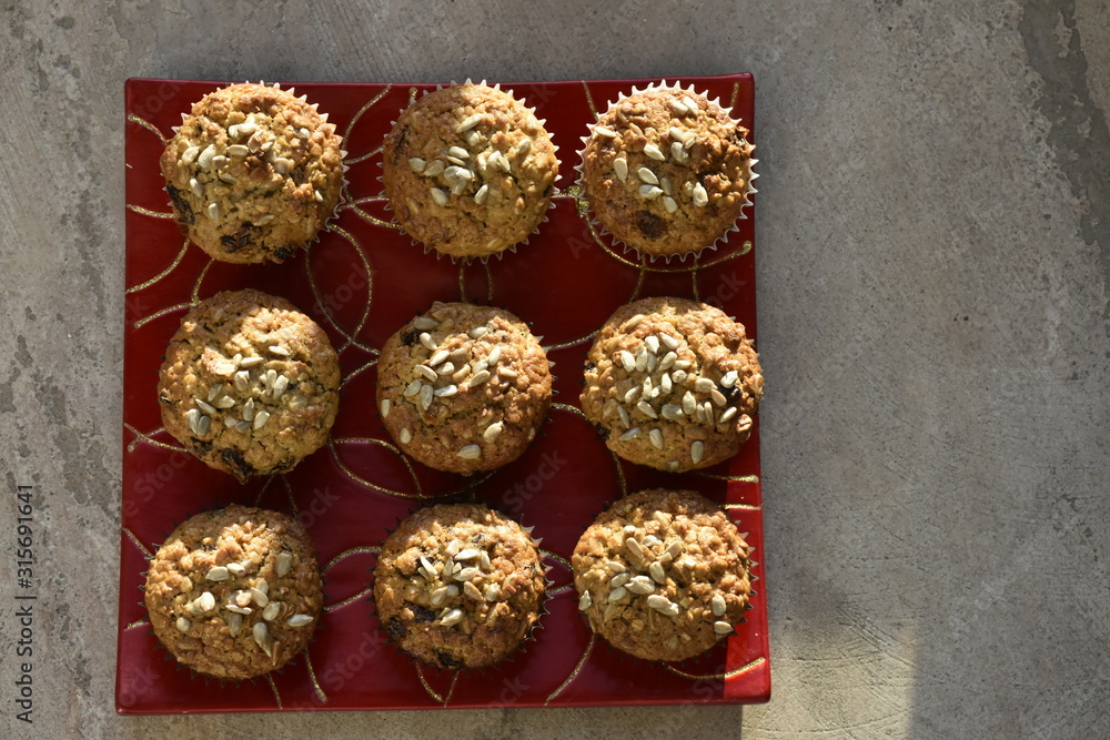 Titel: Healthy muffin with sunflower seeds oatmeal and raisins on wooden table Titel: Healthy muffin with sunflower seeds oatmeal and raisins on wooden table