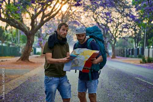 Backpackers with map on a street, Pretoria, South Africa photo