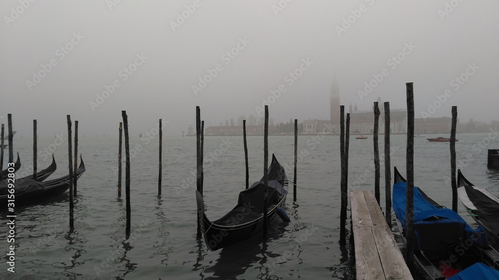 Venice waterfront with gondolas and misty waterscape