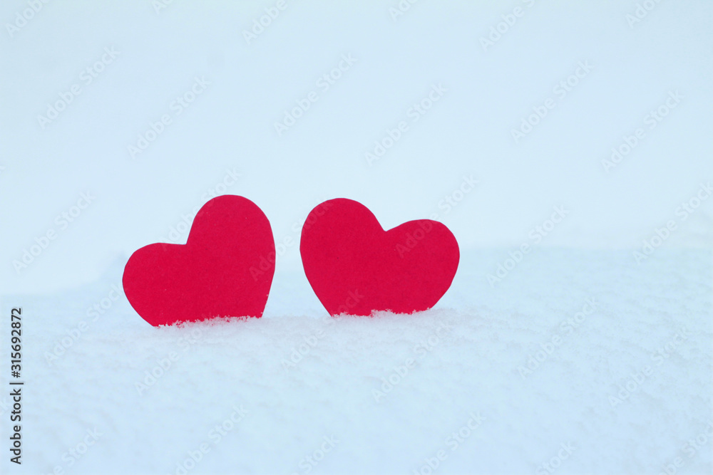 Two red felt hearts on the snow. Handmade for the celebration and holiday. Stock Photography for Valentine's Day with empty space for your text. For web, print, cards, invitations and wallpapers. Two red felt hearts on the snow. Handmade for the celebration and holiday. Stock Photography for Valentine's Day with empty space for your text. For web, print, cards, invitations and wallpapers.